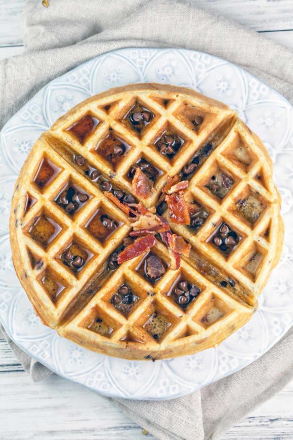 overhead images of a bacon chocolate chip waffle with syrup and extra chocolate chips and bacon sprinkled on top