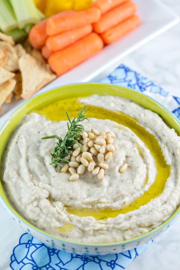 bowl of thick white dip with a swirl of olive oil on the top