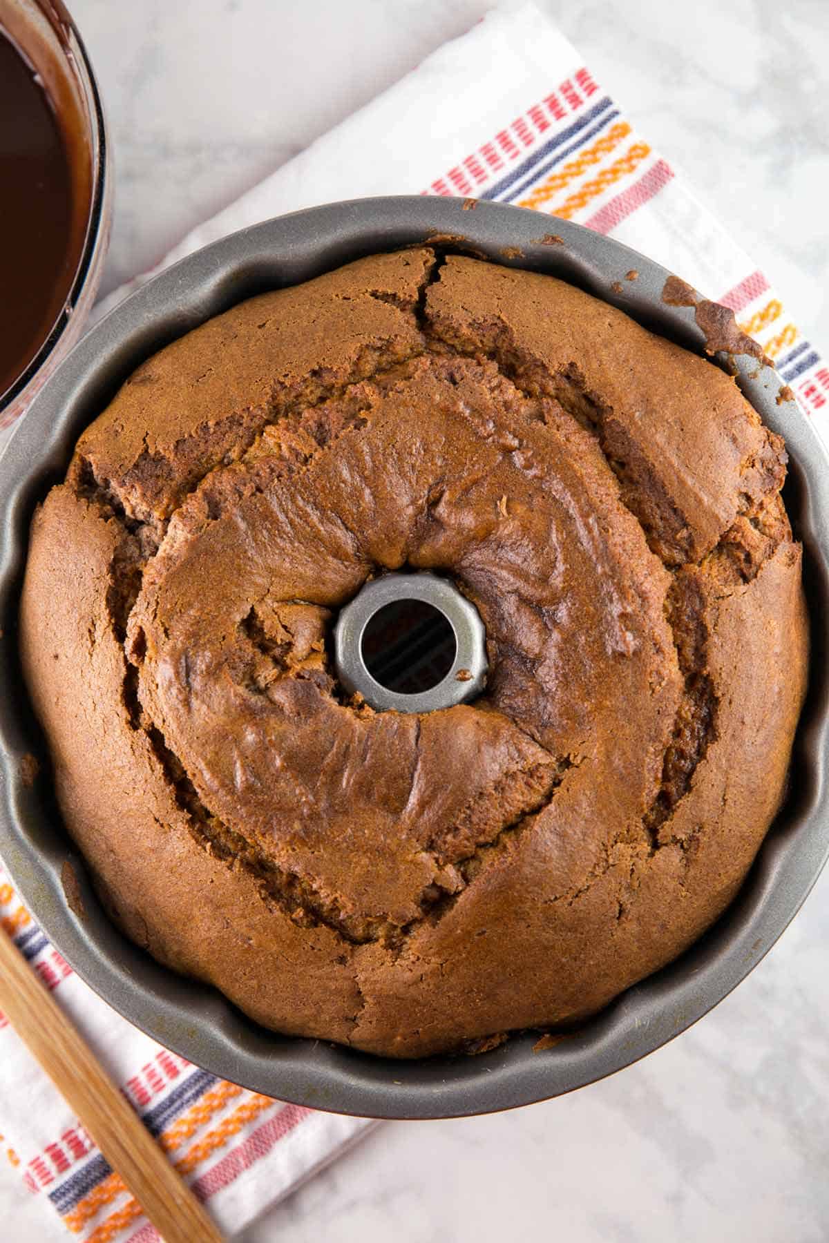 overhead shot of a pumpkin bundt cake still in the bundt pan.