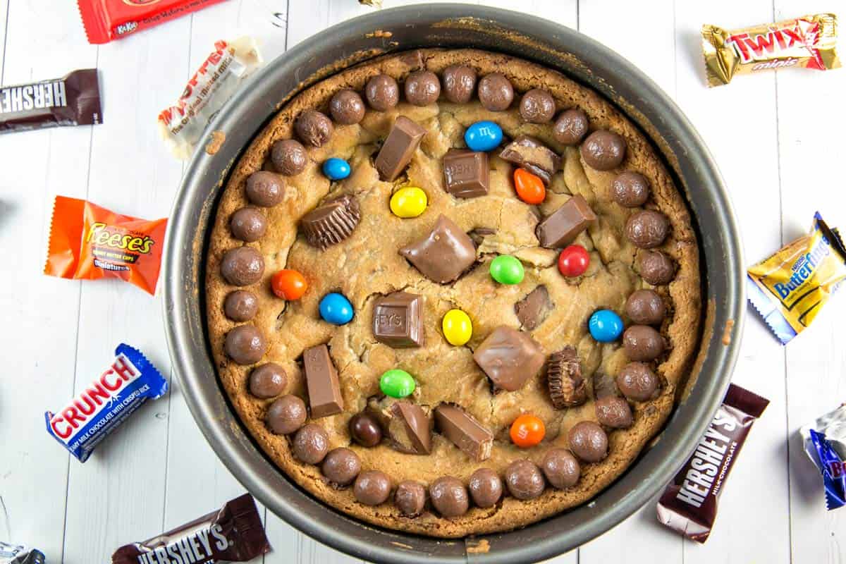 overhead photo of a cookie cake covered in candy in a springform pan