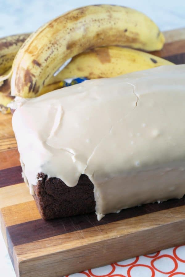 loaf of banana bread covered in a smooth maple glaze