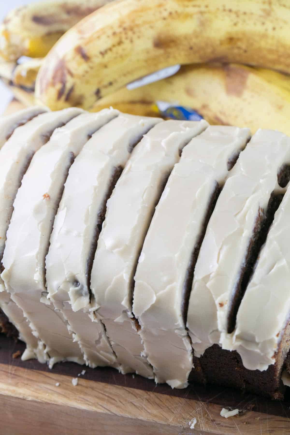 close up image of slices of banana bread with maple icing