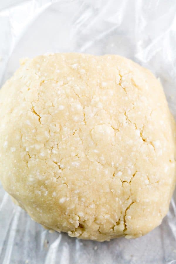 round ball of pie crust dough with visible specks of butter