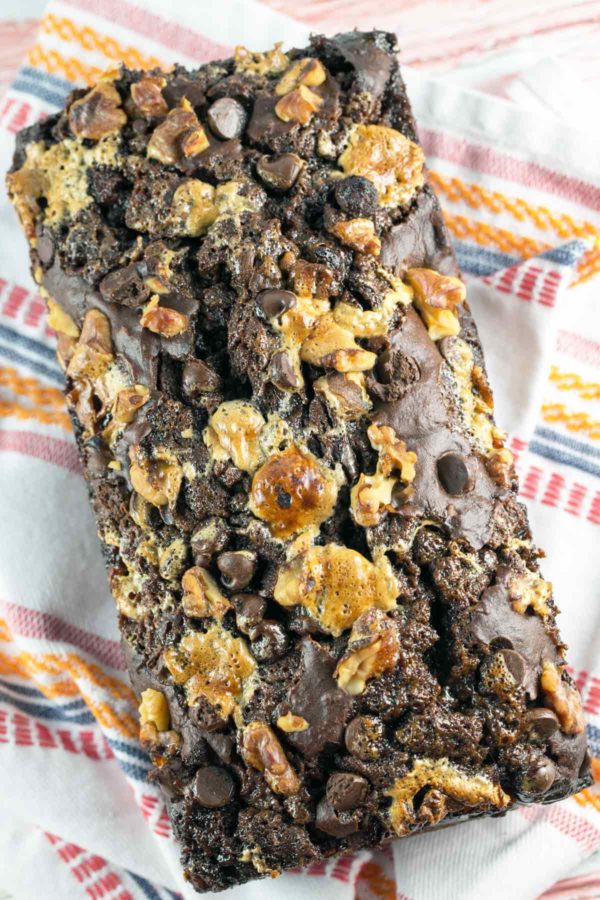 loaf of chocolate rocky road banana bread topped with marshmallows and walnuts