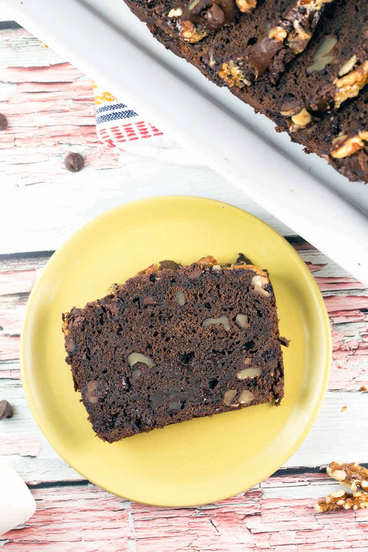 overhead photo of a slice of chocolate banana bread on a yellow plate