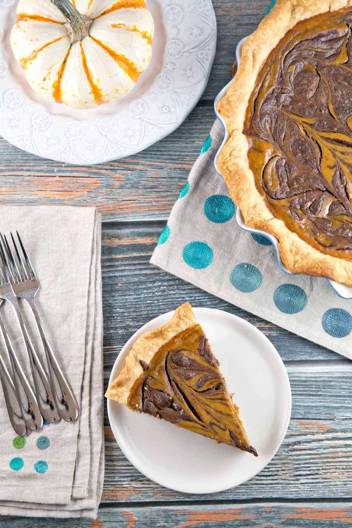 one slices of nutella swirled pumpkin pie removed on a small gray plate