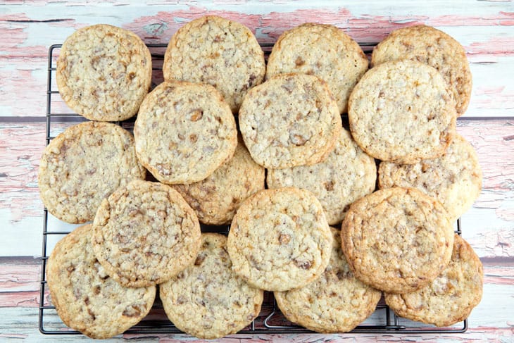 a pile of homemade toffee cookies on a metal cooling rack.