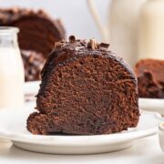 slice of chocolate bundt cake highlighting the rich fudgy interior.