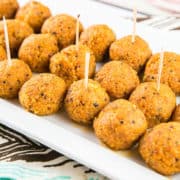 Spicy Buffalo Quinoa Bites: the perfect vegetarian and gluten-free appetizer for your football party or tailgate! Crispy quinoa surrounding a melted cheesy center, covered in spicy buffalo sauce. A hit with both meat eaters and vegetarians alike! {Bunsen Burner Bakery} #vegetarian #glutenfree #superbowlparty #appetizers