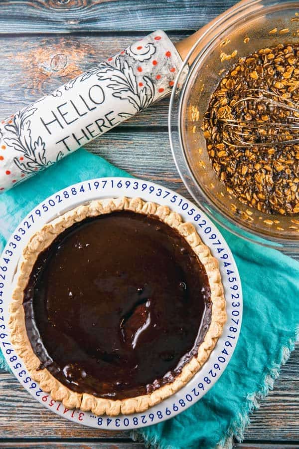 baked pie crust with a layer of chocolate ganache lining the crust