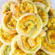 a pile of puff pastry pinwheels stuffed with jalapenos and cream cheese