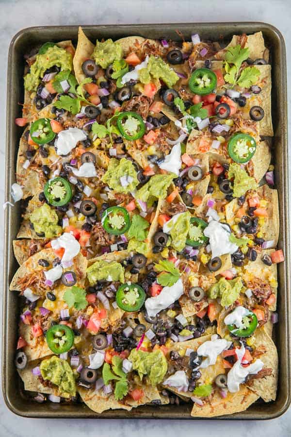 Sheet Pan Nachos: the ultimate loaded nachos are just 10 minutes and one sheet pan away. Easy entertaining - perfect for parties... or dinner! {Bunsen Burner Bakery} #nachos #appetizers #partyfood #superbowl