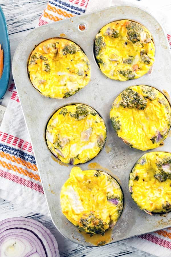 a six well muffin tin filled with smoked salmon egg muffins.