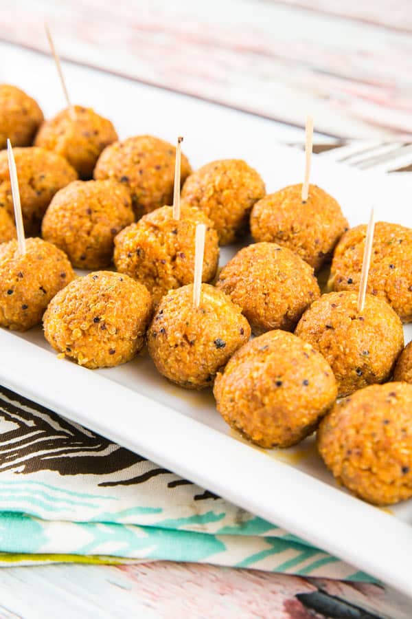 Spicy Buffalo Quinoa Bites: the perfect vegetarian and gluten-free appetizer for your football party or tailgate! Crispy quinoa surrounding a melted cheesy center, covered in spicy buffalo sauce. A hit with both meat eaters and vegetarians alike! {Bunsen Burner Bakery} #vegetarian #glutenfree #superbowlparty #appetizers