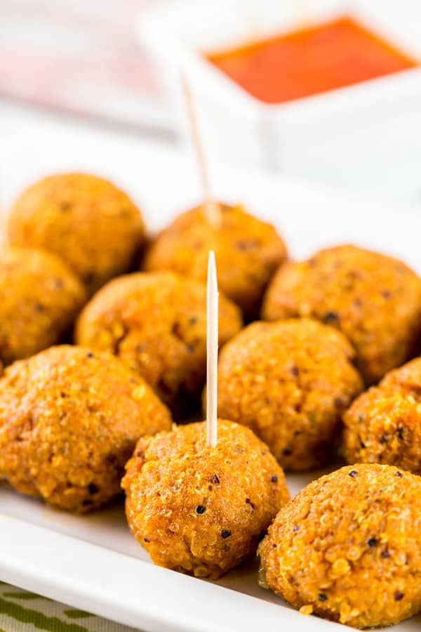 Spicy Buffalo Quinoa Bites: the perfect vegetarian and gluten-free appetizer for your football party or tailgate! Crispy quinoa surrounding a melted cheesy center, covered in spicy buffalo sauce. A hit with both meat eaters and vegetarians alike! {Bunsen Burner Bakery} #vegetarian #glutenfree #superbowlparty #appetizers