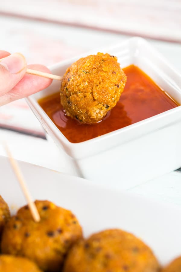 Spicy Buffalo Quinoa Bites: the perfect vegetarian and gluten-free appetizer for your football party or tailgate! Crispy quinoa surrounding a melted cheesy center, covered in spicy buffalo sauce. A hit with both meat eaters and vegetarians alike! {Bunsen Burner Bakery} #vegetarian #glutenfree #superbowlparty #appetizers