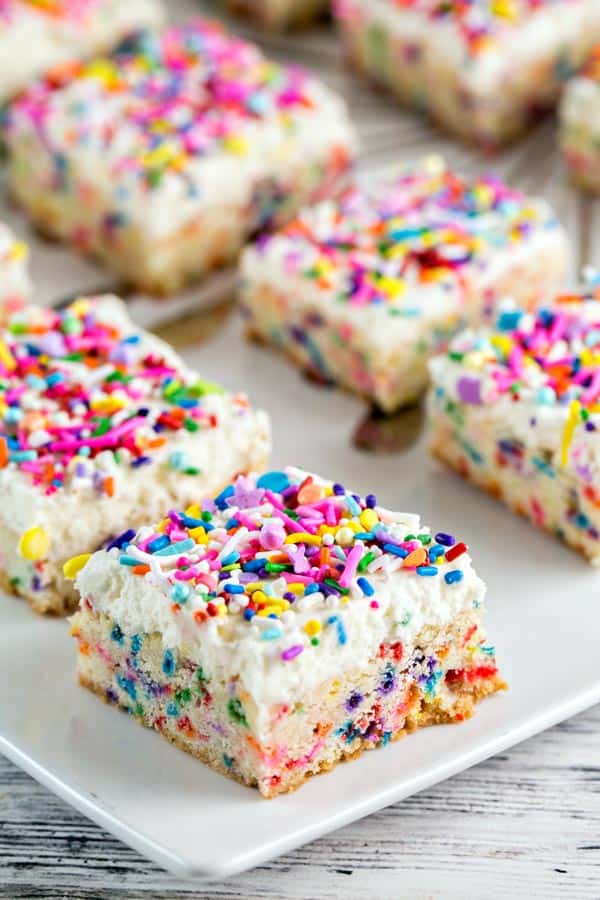 side view of funfetti cookie bars showing the bright sprinkles inside.