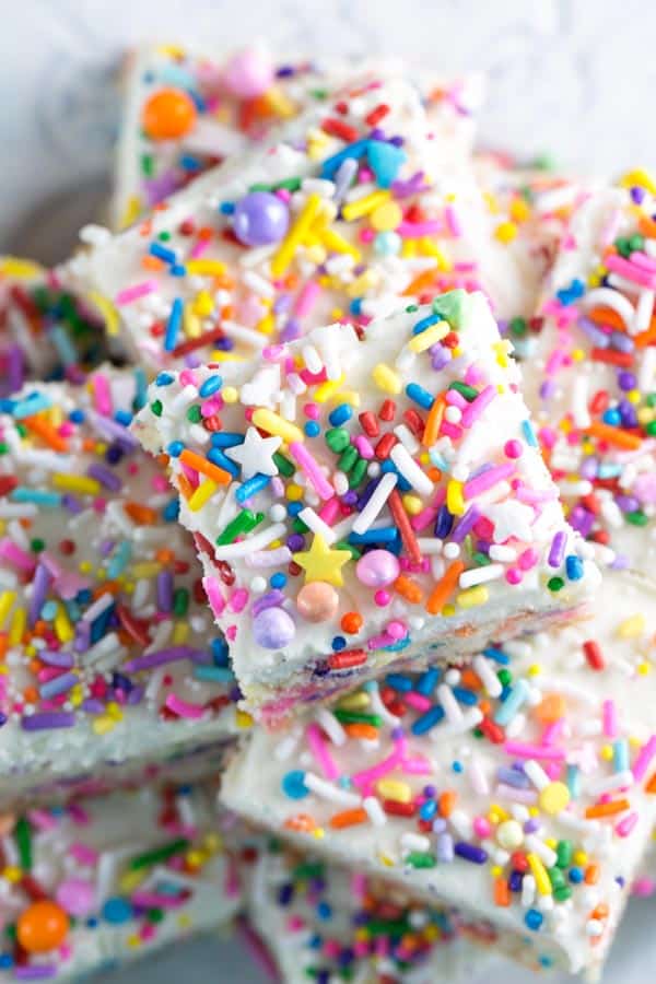 close up view of the fancy brighly colored sprinkles covering sugar cookie bars.