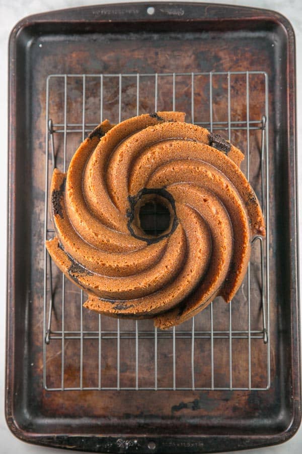 unglazed bundt cake on a wire cooling rack.