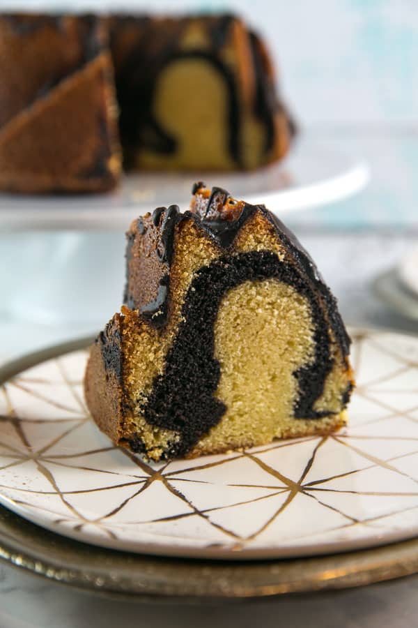 single slice of marble bundt cake showing the dark chocolate swirl in the middle.