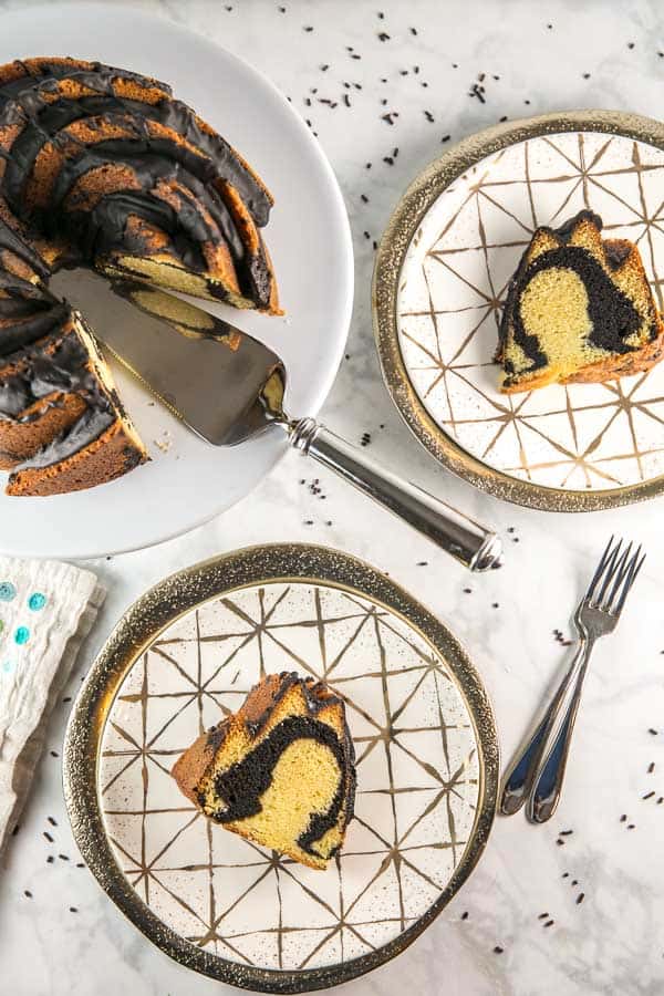 marble bundt cake on decorative gold plates with gold chargers.