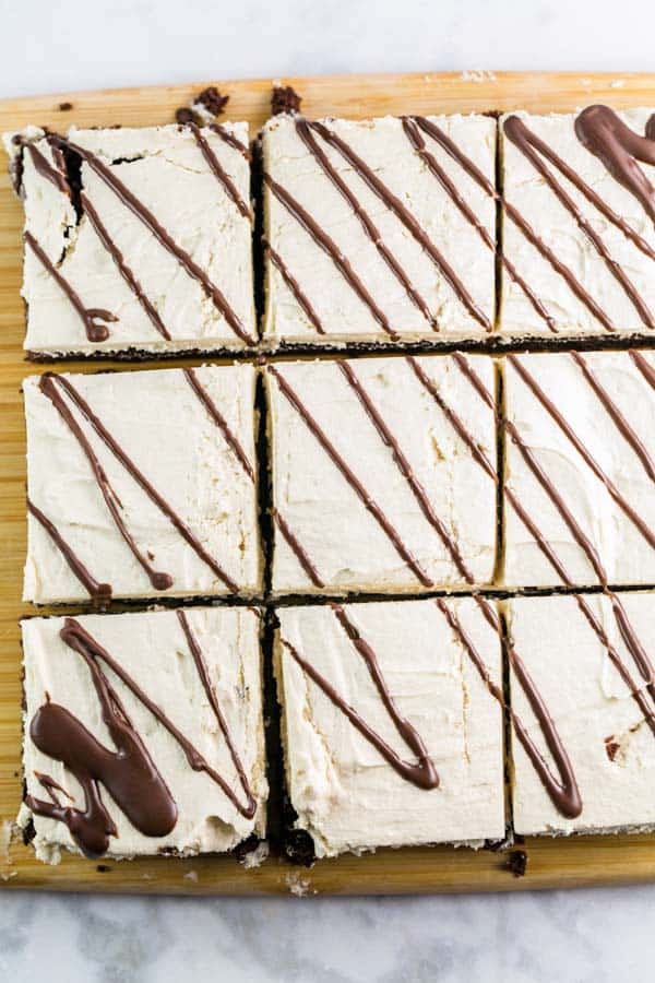 cut squares of brownies with drizzles of melted chocolate.