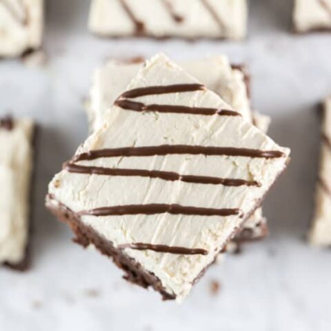 stack of fudgy brownies covered in fluffy salted tahini buttercream