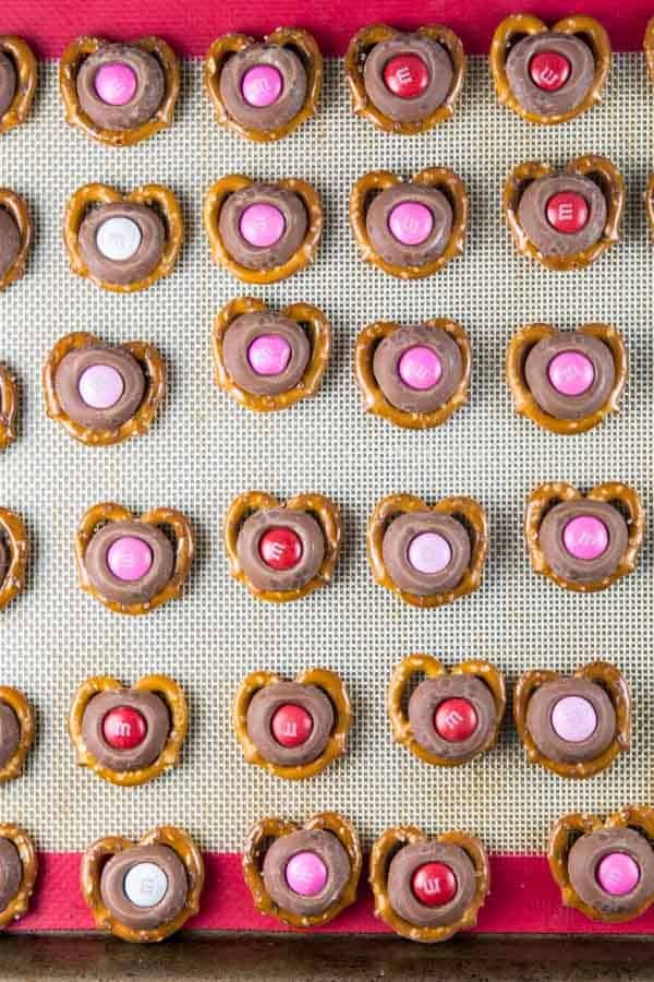 overhead view of m&m pretzel kisses on a sheet pan