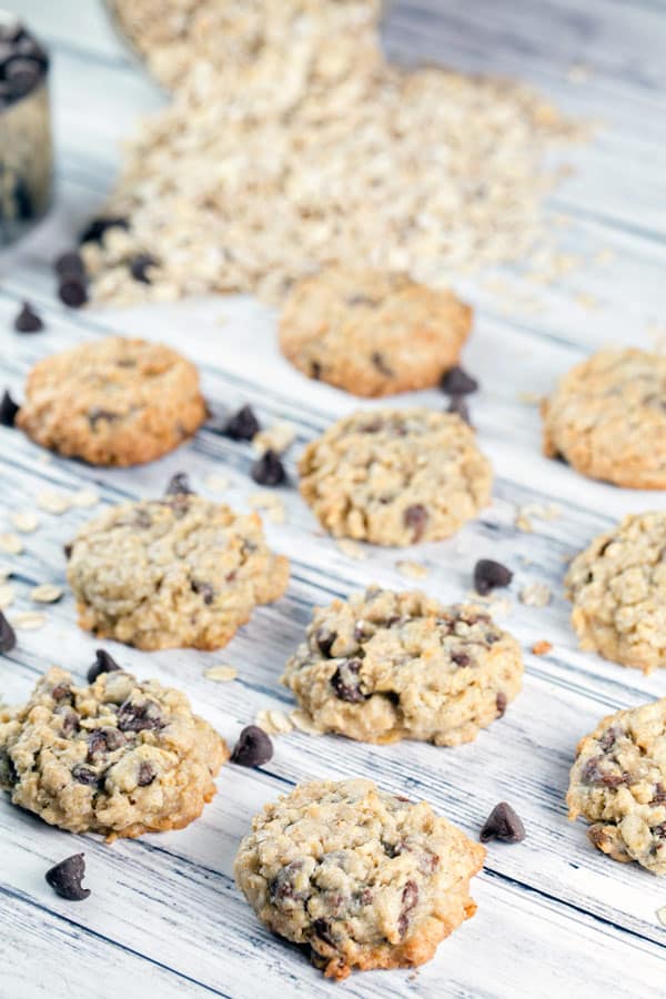 rows oatmeal chocolate chip cookies surrounded by chocolate chips and oats