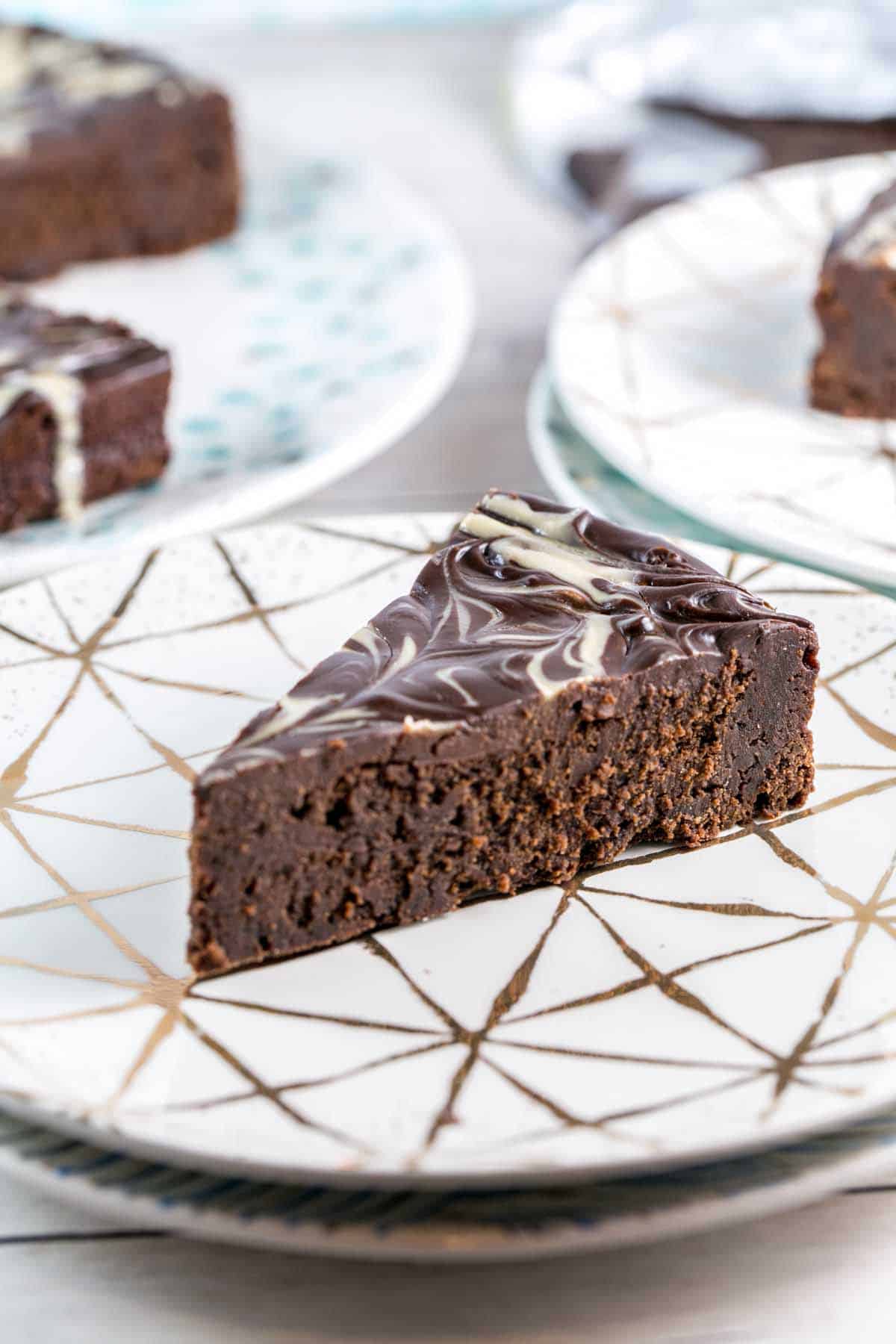 side view of a slice of chocolate tahini cake showing the thick, fudgy texture