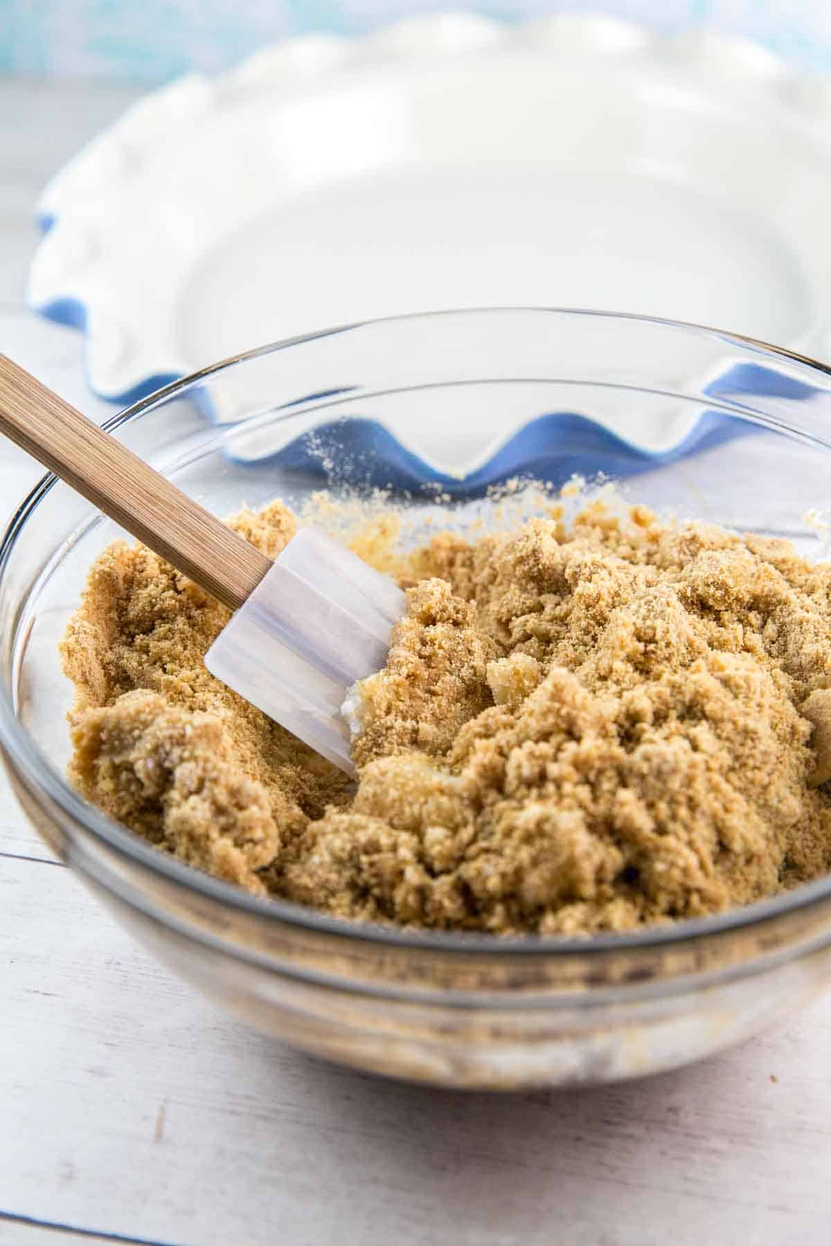 graham cracker crumbs and melted butter in a mixing bowl