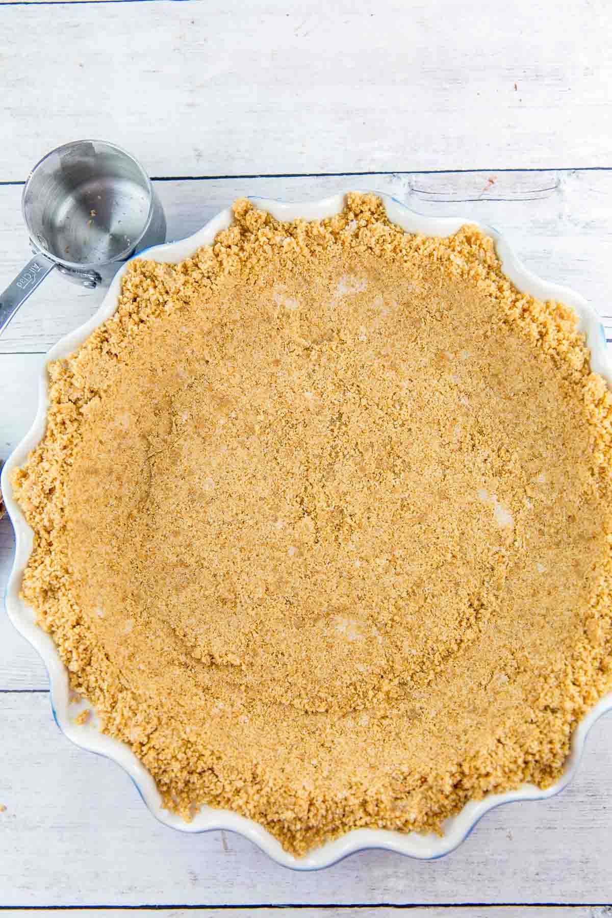 graham cracker crust pressed into a fluted ceramic pie plate