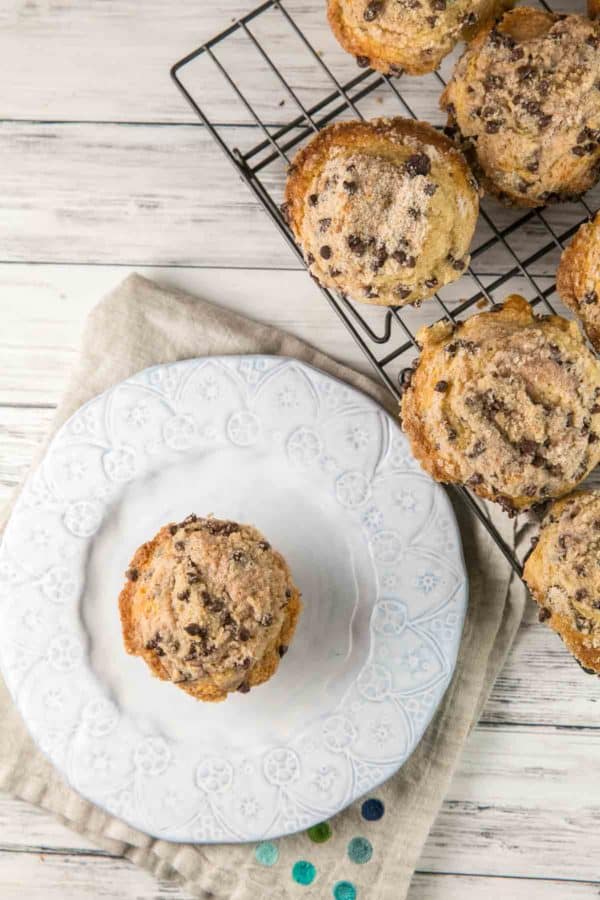 domed chocolate chip muffin on a decorative dessert plate