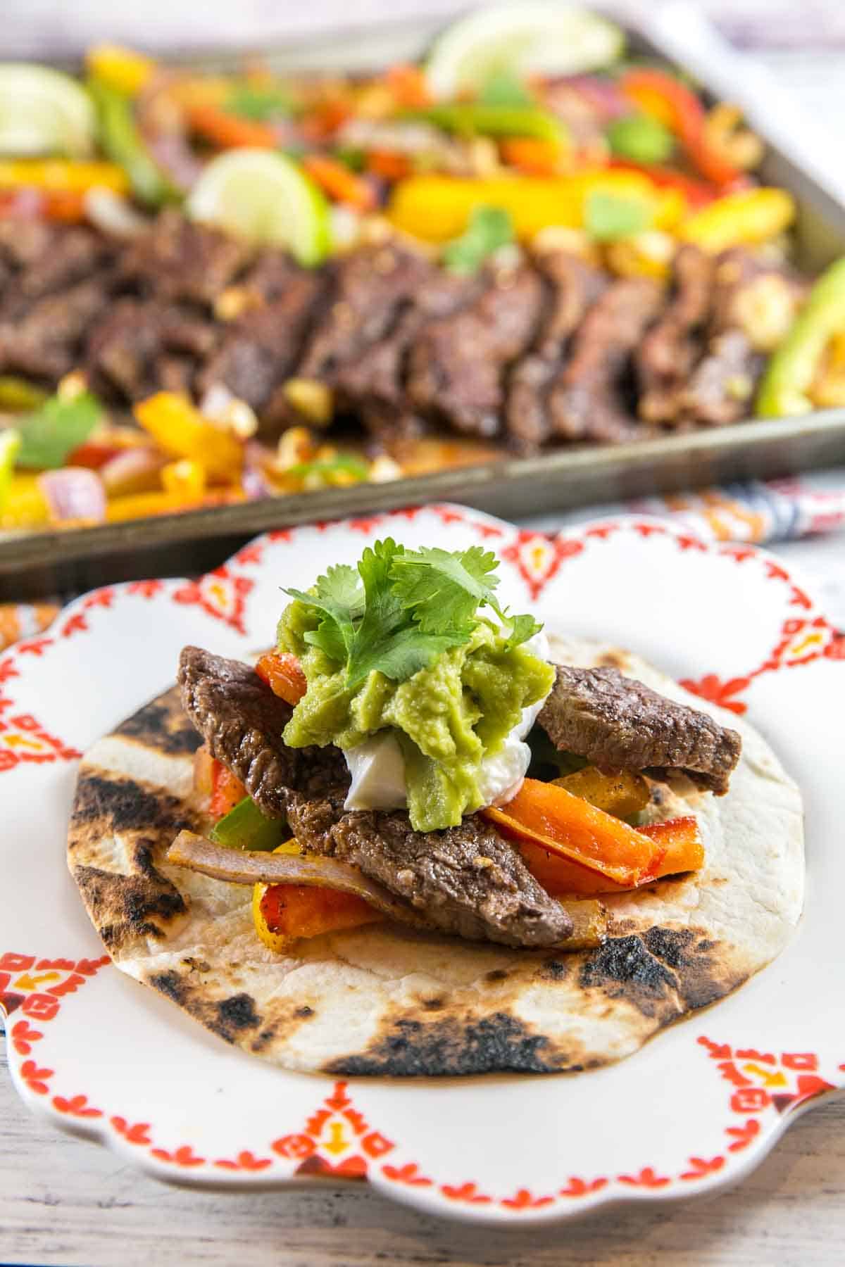 grilled peppers and steak piled on a slightly charred tortilla