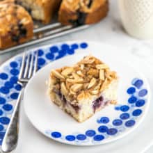 slice of blueberry almond coffee cake on a decorative dessert plate