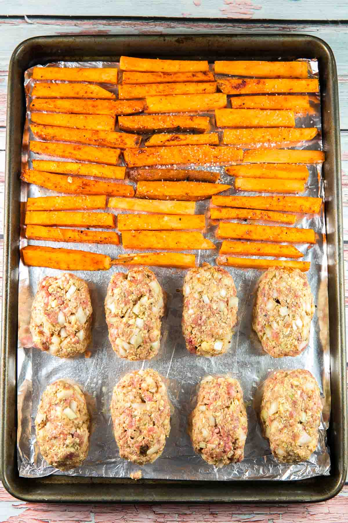 sheet pan with 8 mini meatloaves and thinly sliced sweet potato fries.