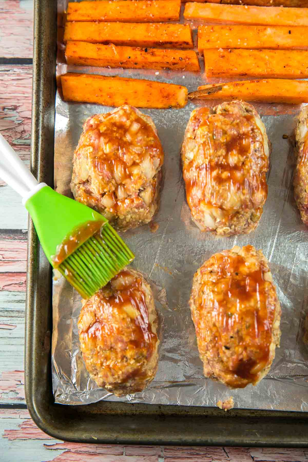 brushing the top of meatloaves with ketchup.