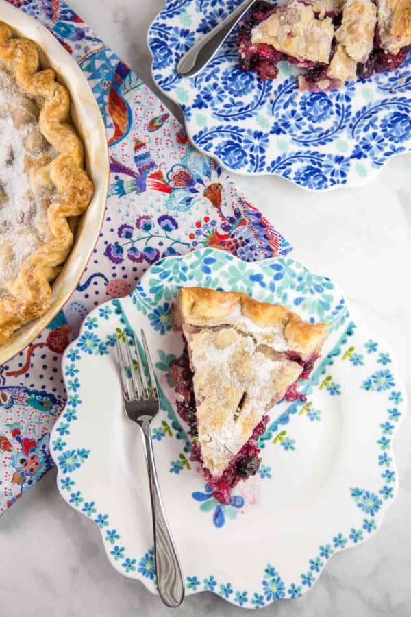 slice of blueberry rhubarb pie on floral decorative dessert plates
