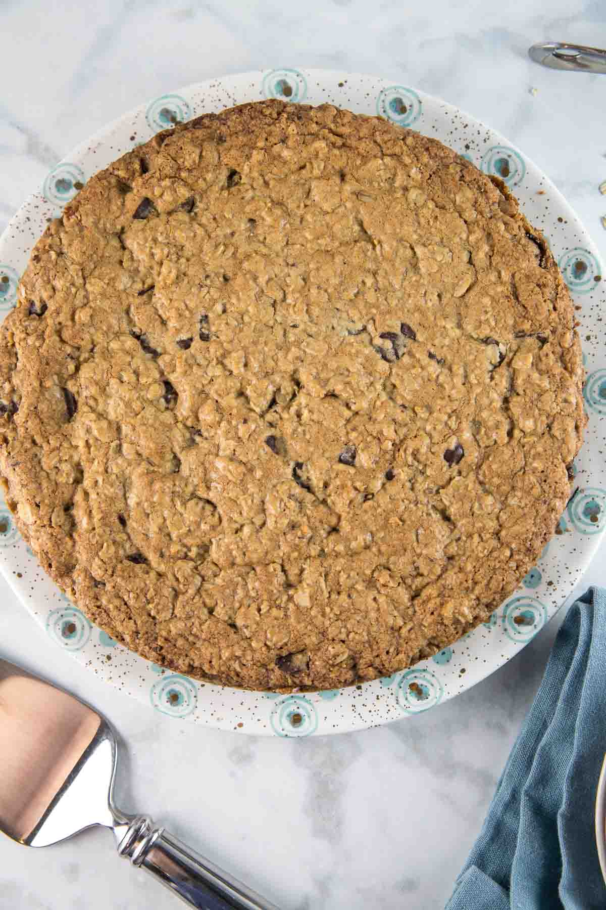 giant oatmeal cookie cake on a decorative dessert plate