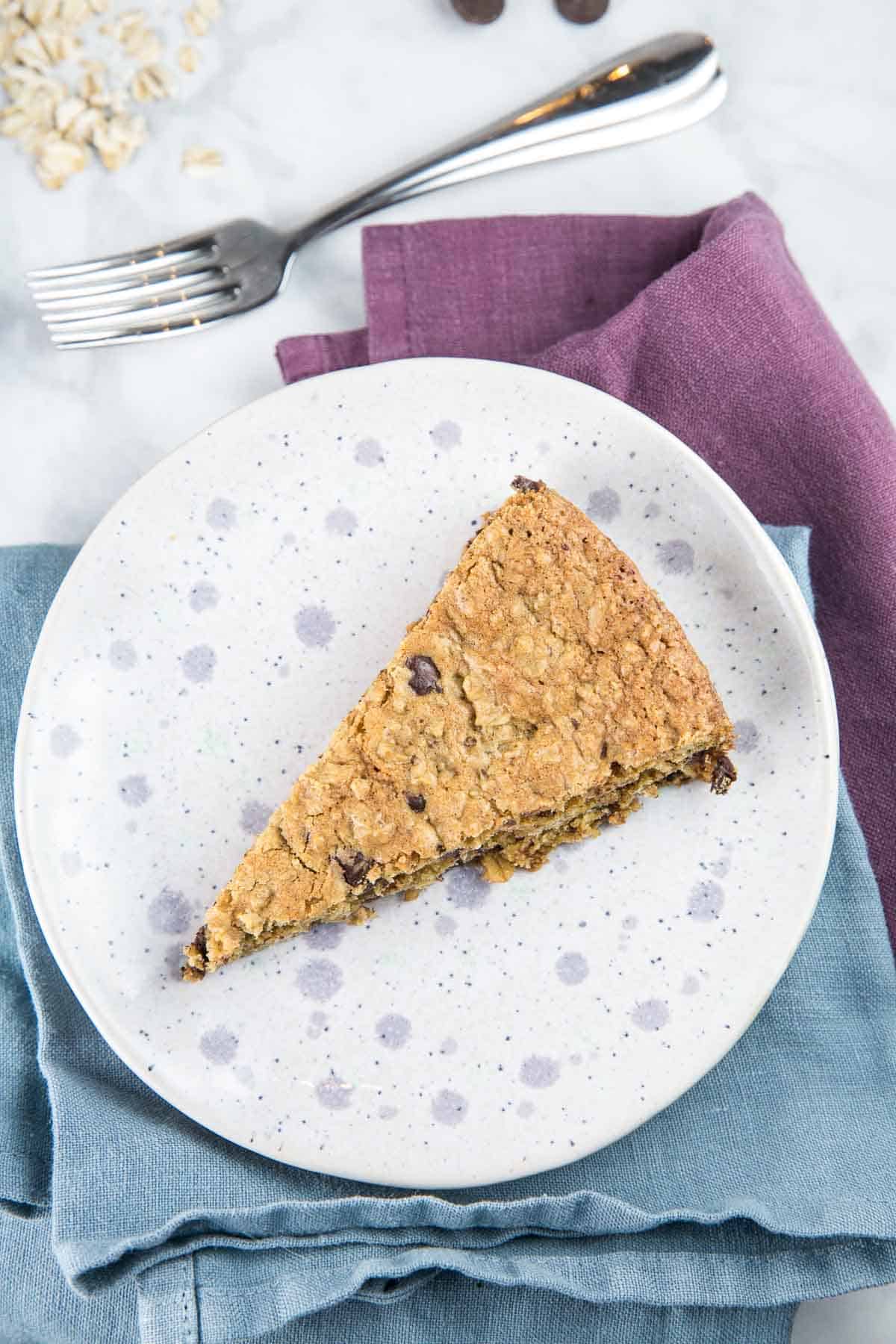 slice of an oatmeal cookie cake on a purple tinted dessert plate
