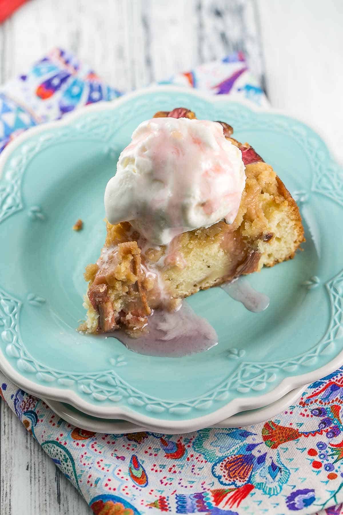 slice of rhubarb cake with a big scoop of ice cream on top