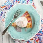 slice of rhubarb almond coffee cake with a scoop of ice cream on top