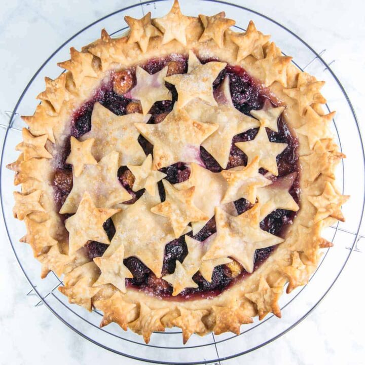 homemade cherry pie covered with cutout star-shaped crust