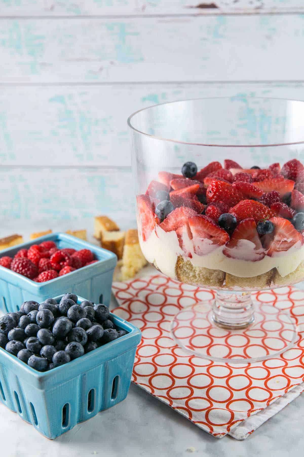 side view of a partially assembled trifle in a glass bowl