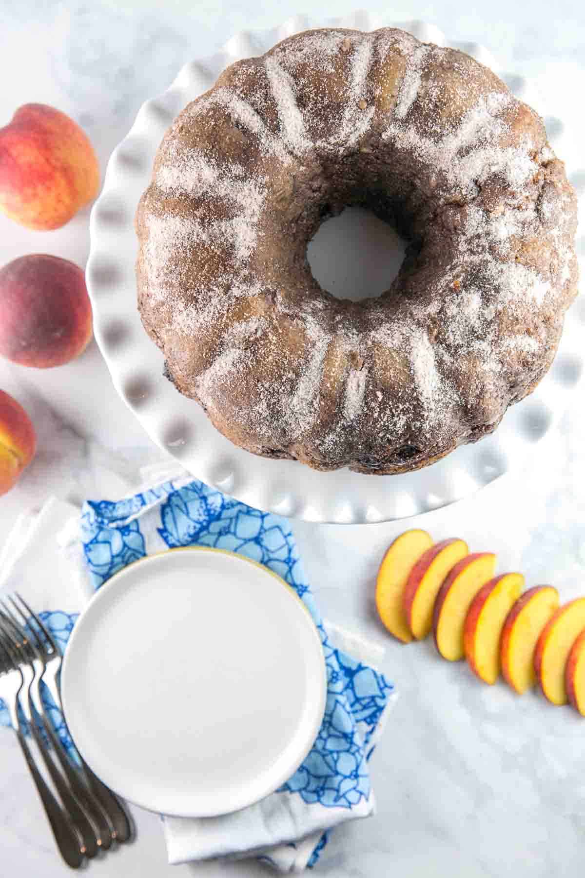 cinnamon sugar coated bundt cake on a white cake stand