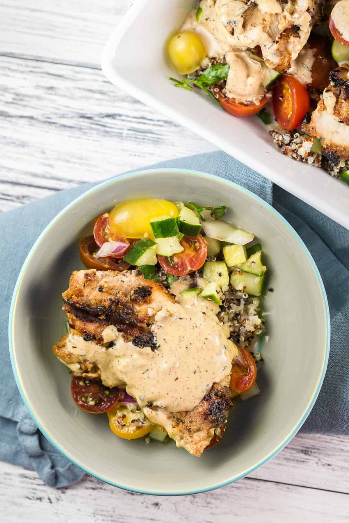 tahini chicken in a bowl on a decorative linen napkin