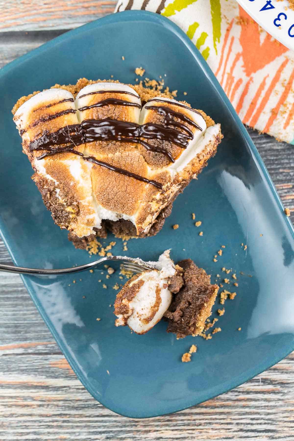 slice of pie with one forkful removed sitting on the edge of the plate