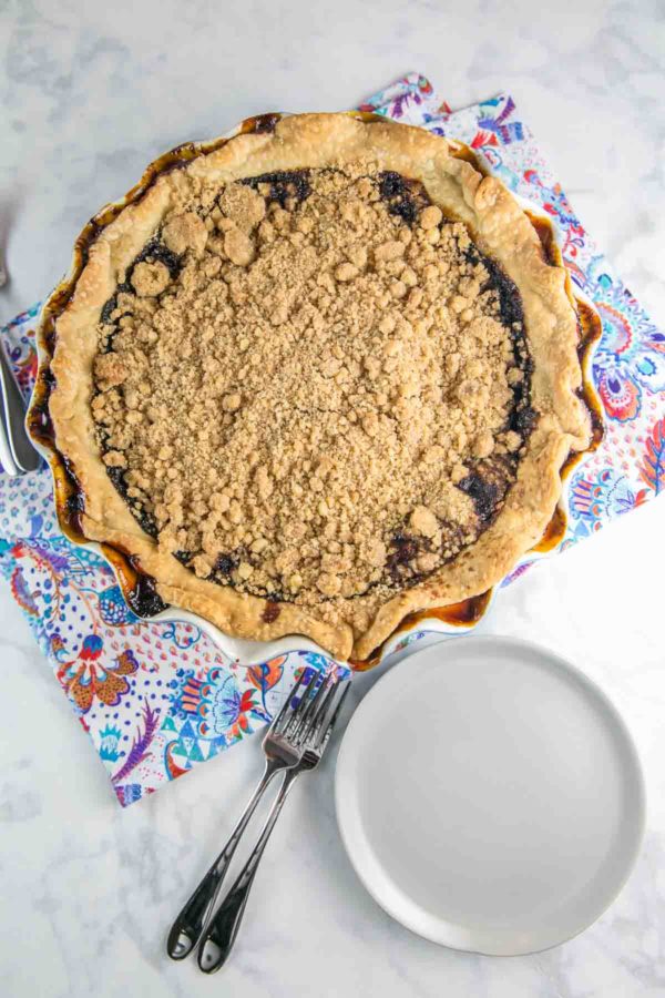 whole uncut chocolate shoofly pie with homemade pie crust on a paisley kitchen dishtowel