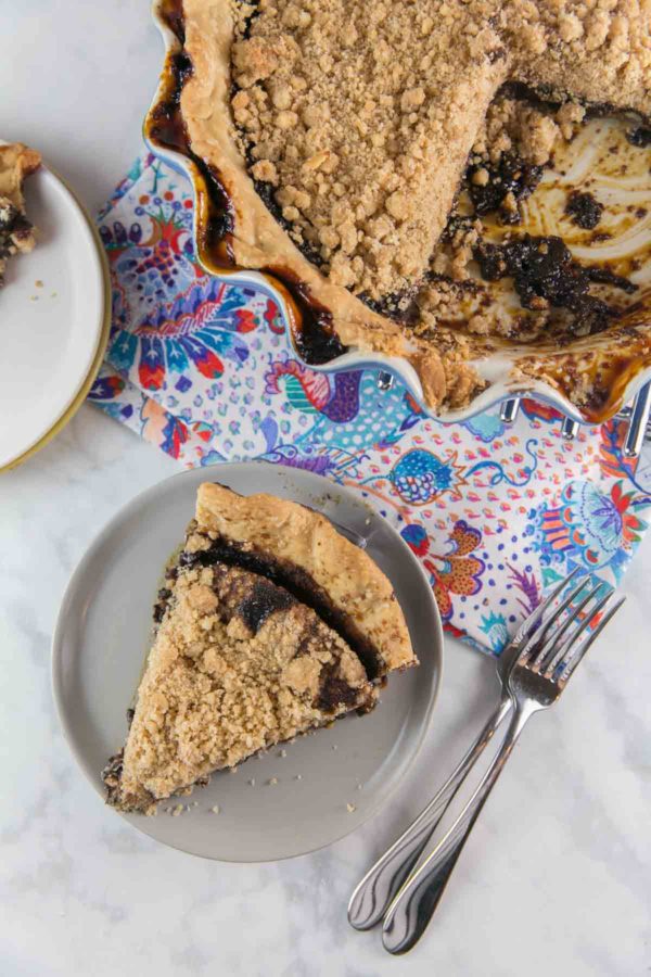 one slice of wet bottom chocolate shoofly pie cut from the pie and served on a gray dessert plate