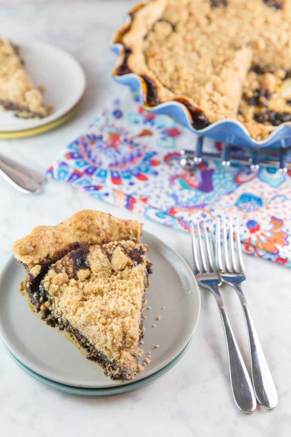 a cut slice of chocolate shoofly pie showing the chocolatey pie bottom and crunchy crumb topping